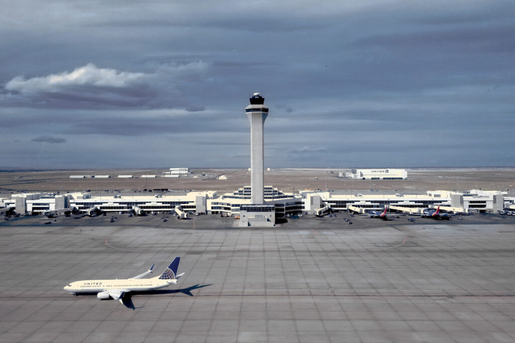 an air traffic control tower high above the airfield
